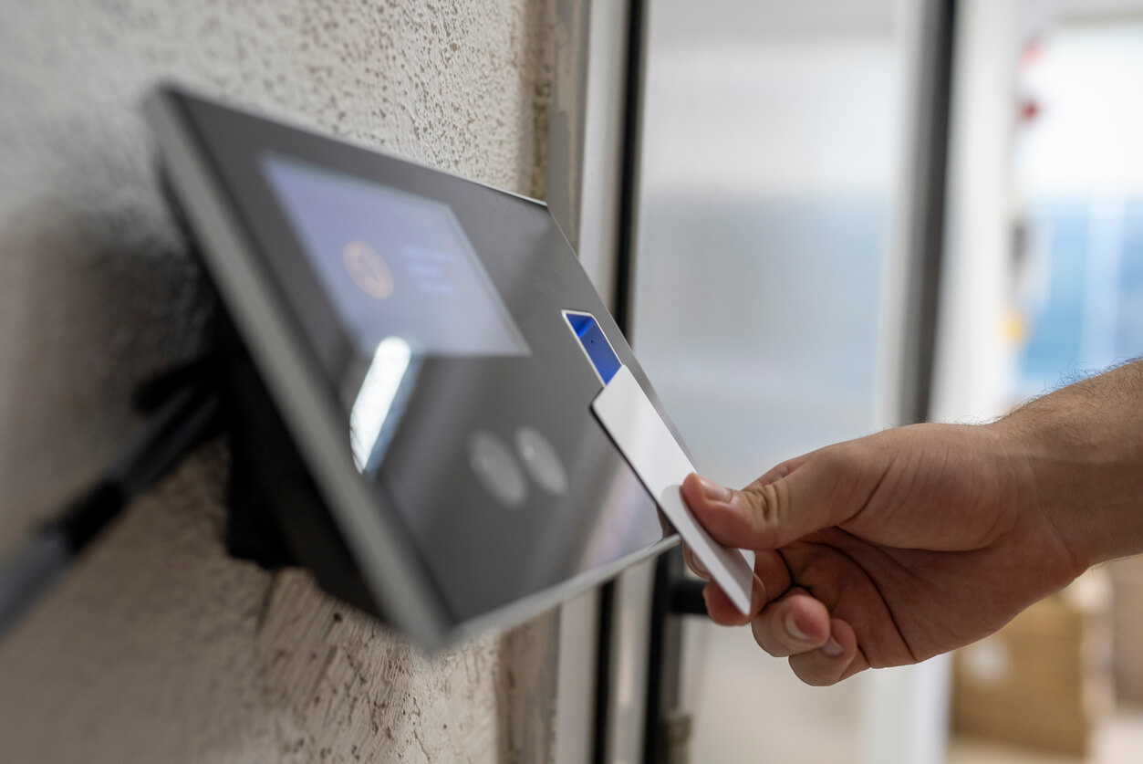 male hand holding key card to accessing the room