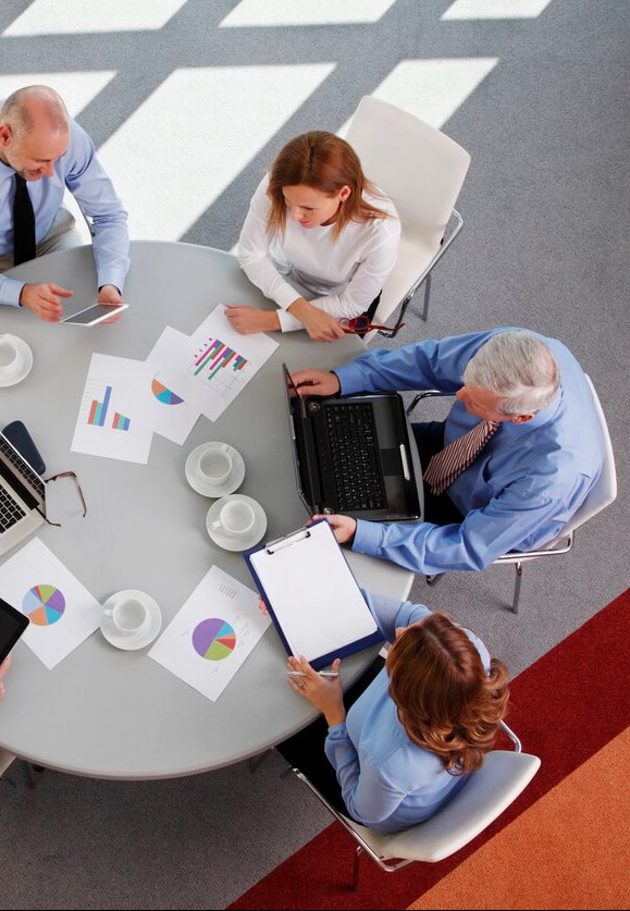 A sales team checking some graphs on a round table